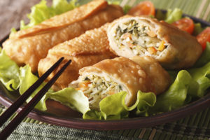 fried spring rolls stuffed with vegetables close-up. Horizontal