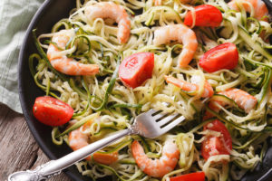 zucchini pasta with shrimp and tomato macro. horizontal top view